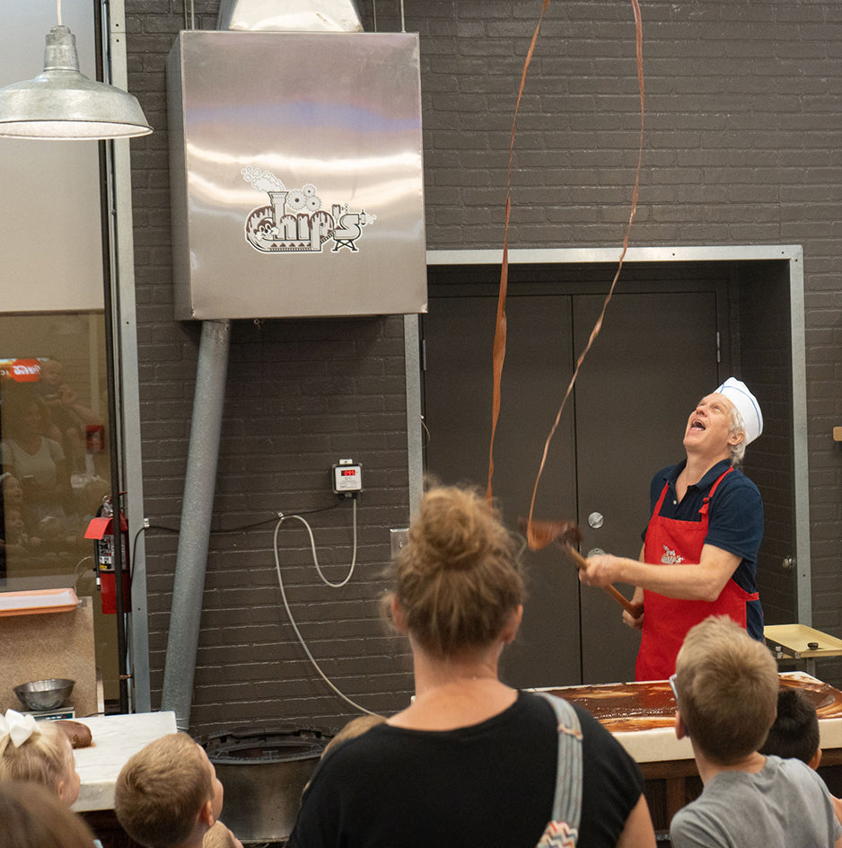 Staff Member Cliff Throws Fudge in for a group tour in store photo